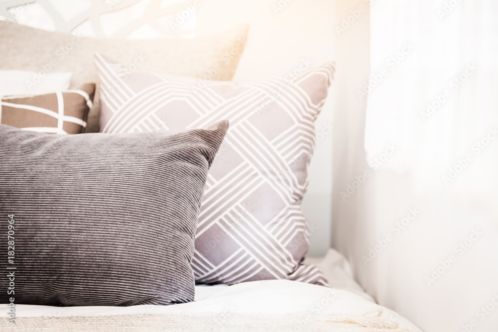 Bed maid-up with clean white pillows and bed sheets in beauty room. Close-up. Lens flair in sunlight