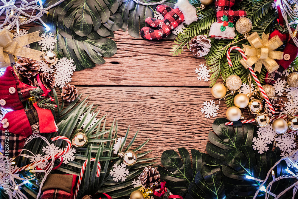 festive background concept with christmas decorating items on wooden background with light filter