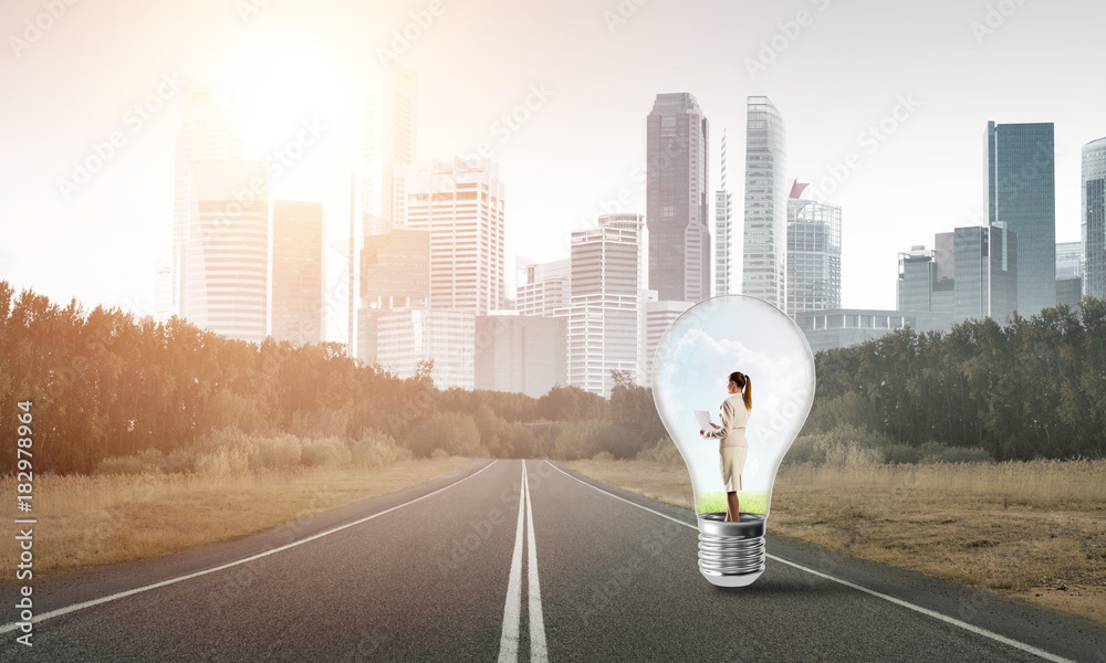 Businesswoman inside light bulb