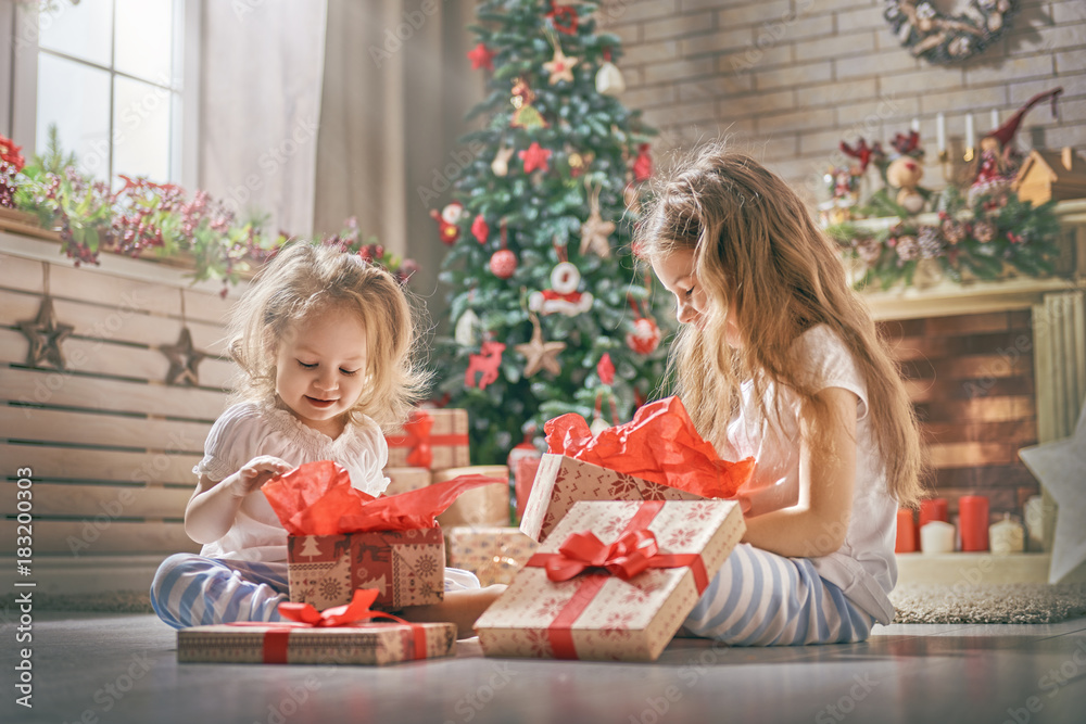 girls opening gifts