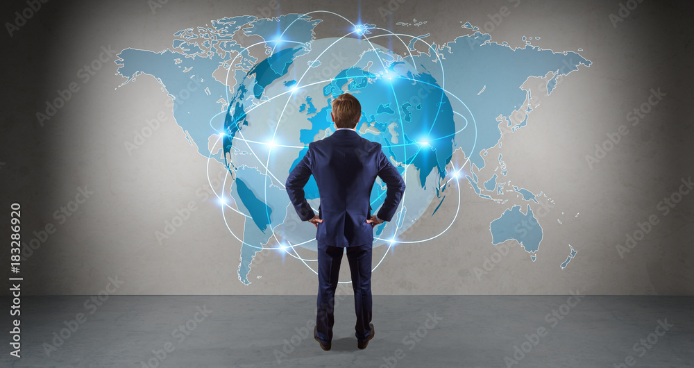 Businessman using digital planet earth interface on a wall 3D rendering