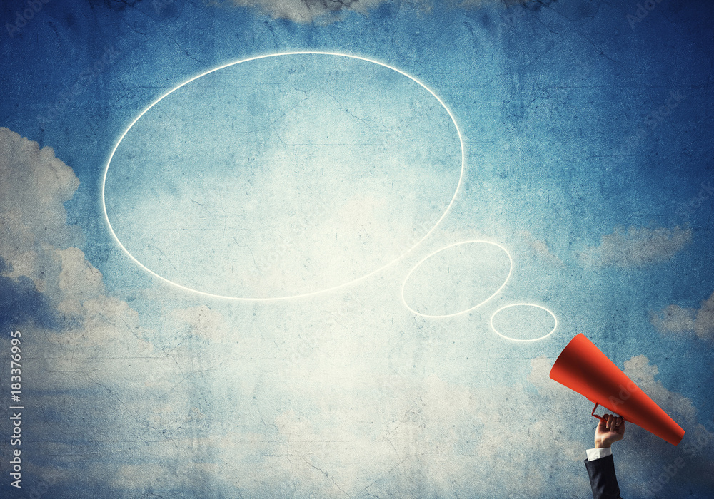 Hand of businesswoman holding red paper trumpet and speech cloud