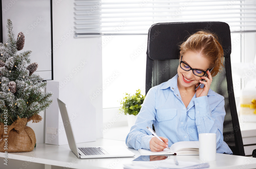 businesswoman freelancer working at a computer at Christmas.