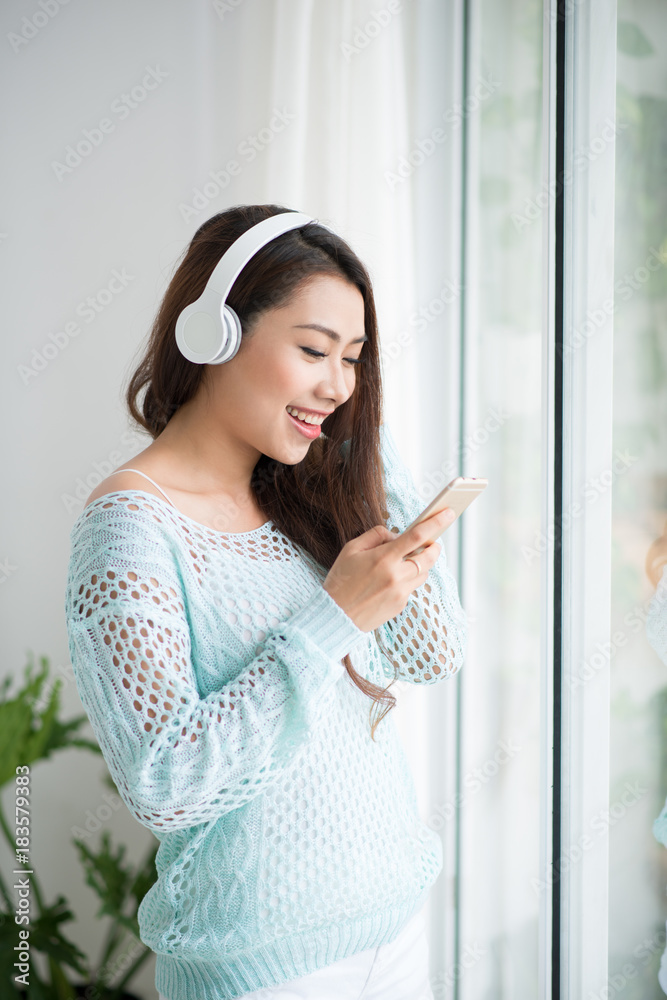 Asian woman enjoying and listening to music.