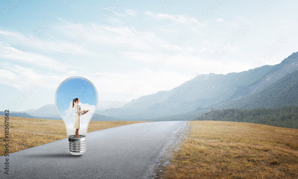 Businesswoman inside light bulb