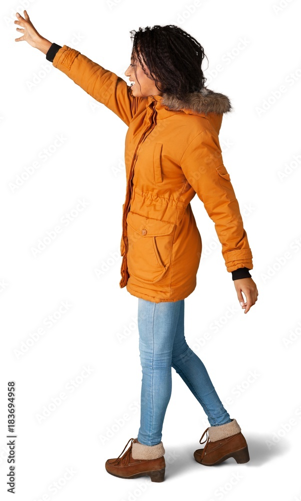 Portrait of young cute african woman in orange coat isolated on