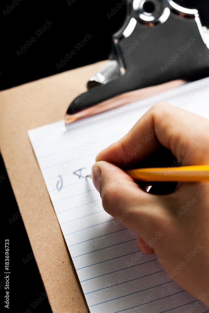 Person Taking Notes on a Clipboard