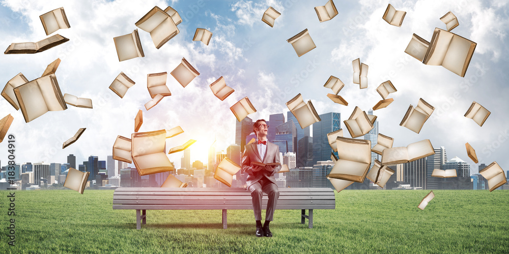 Young businessman or student studying the science in summer park