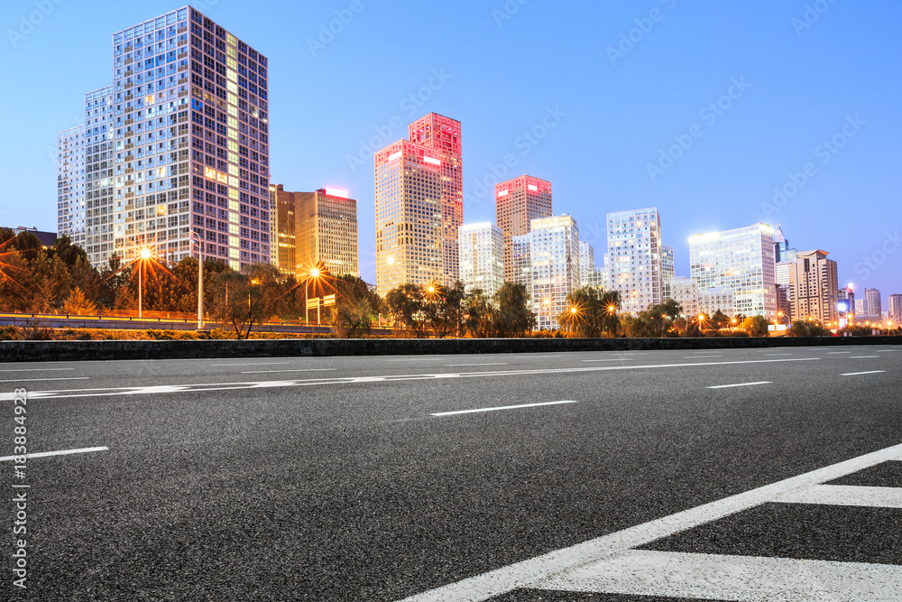 Asphalt highway and modern business district office buildings in Beijing at night,China