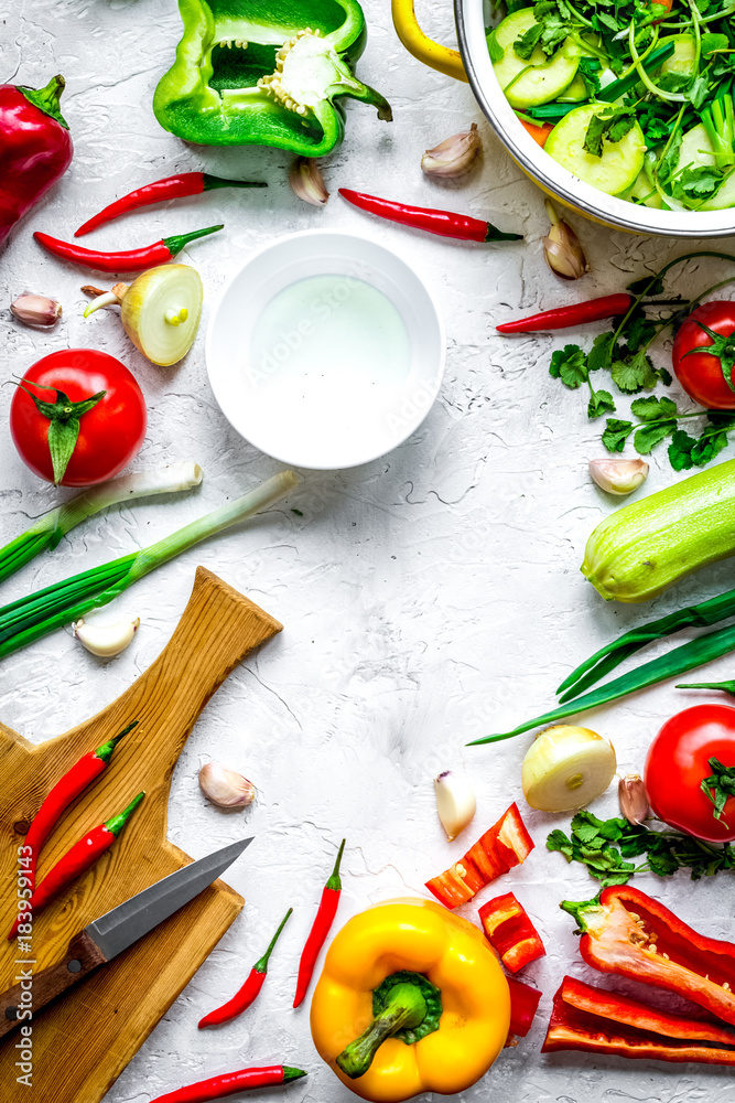 cooking vegetables on the stone background top view