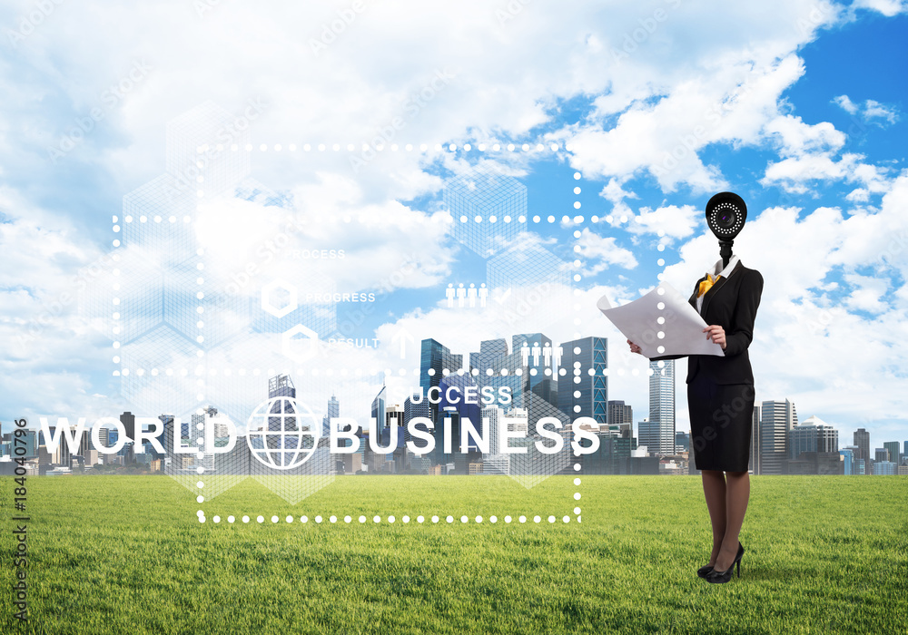 Camera headed woman standing on green grass against modern cityscape