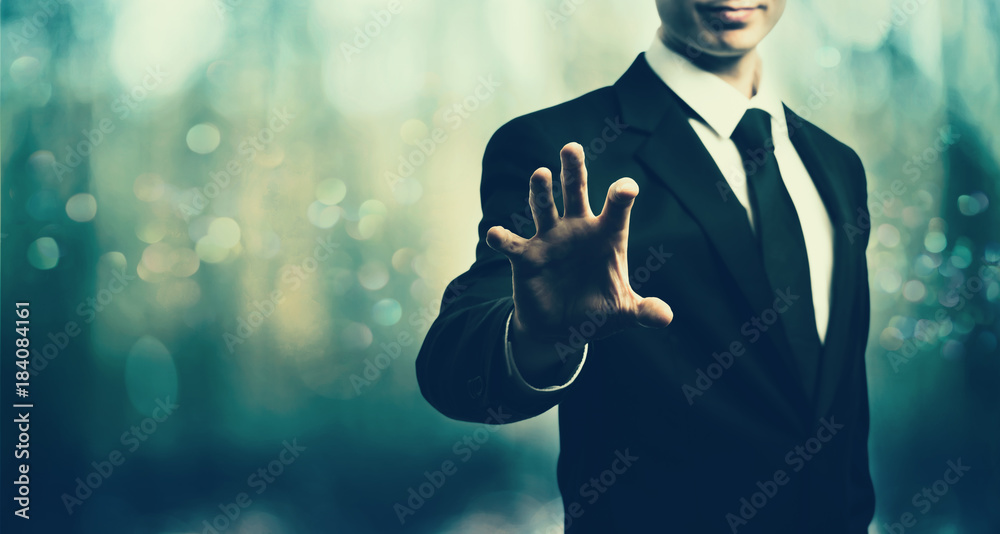 Businessman pointing his fingers on blue abstract light background