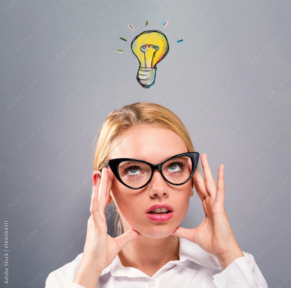 Light Bulb with business woman on a gray background