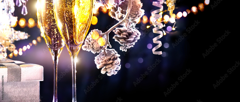 Christmas scene. Flutes with sparkling champagne over holiday background