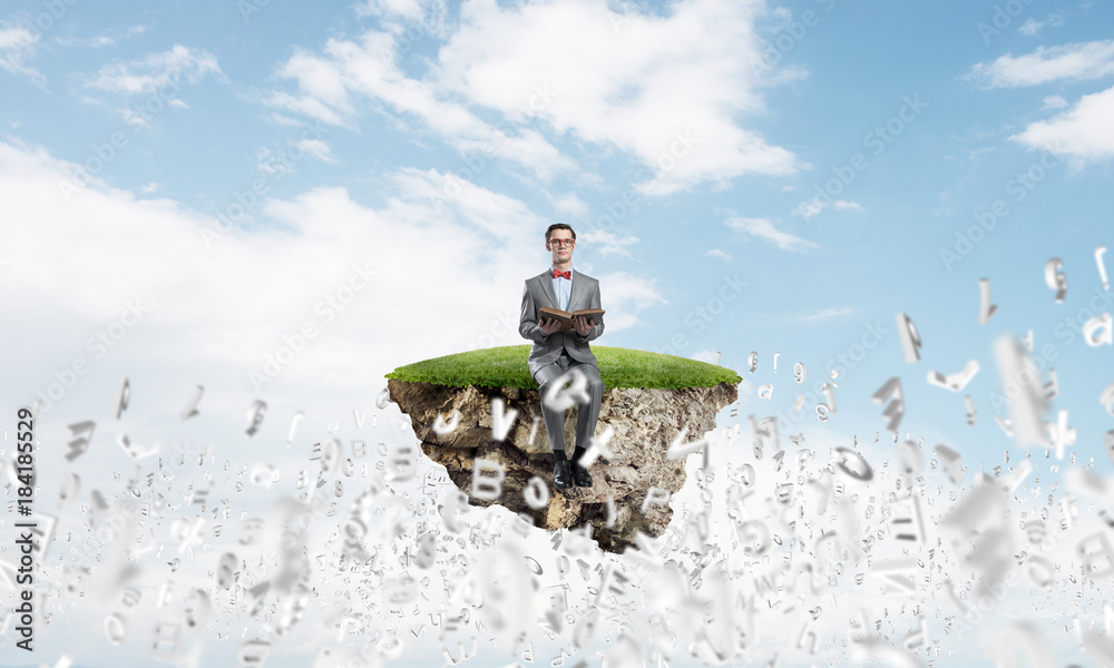 Young businessman or student studying the science and symbols fly around