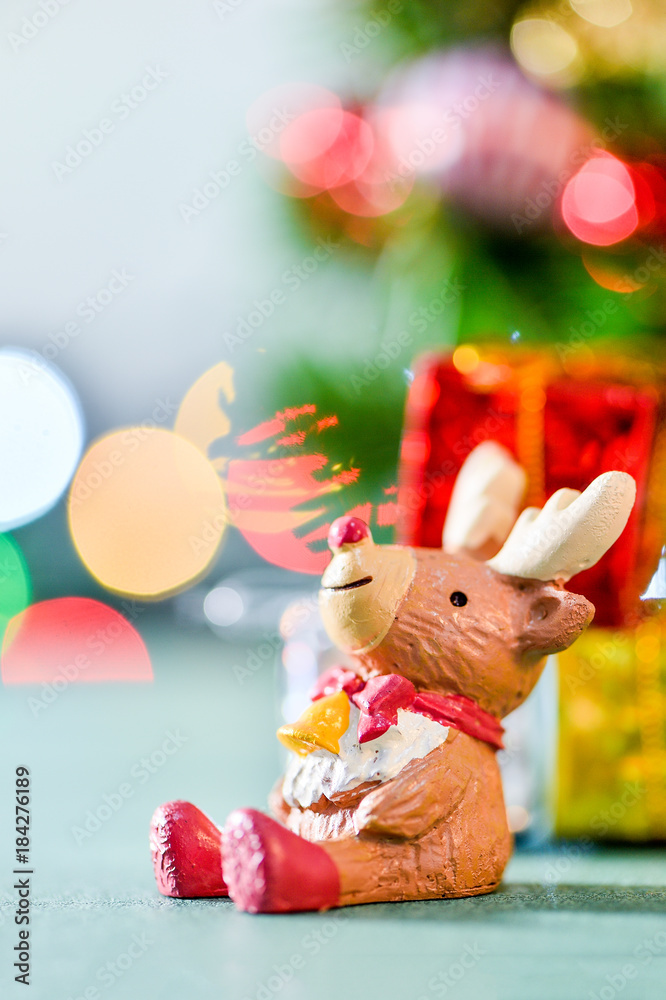 reindeer decoration on colorful light spots background
