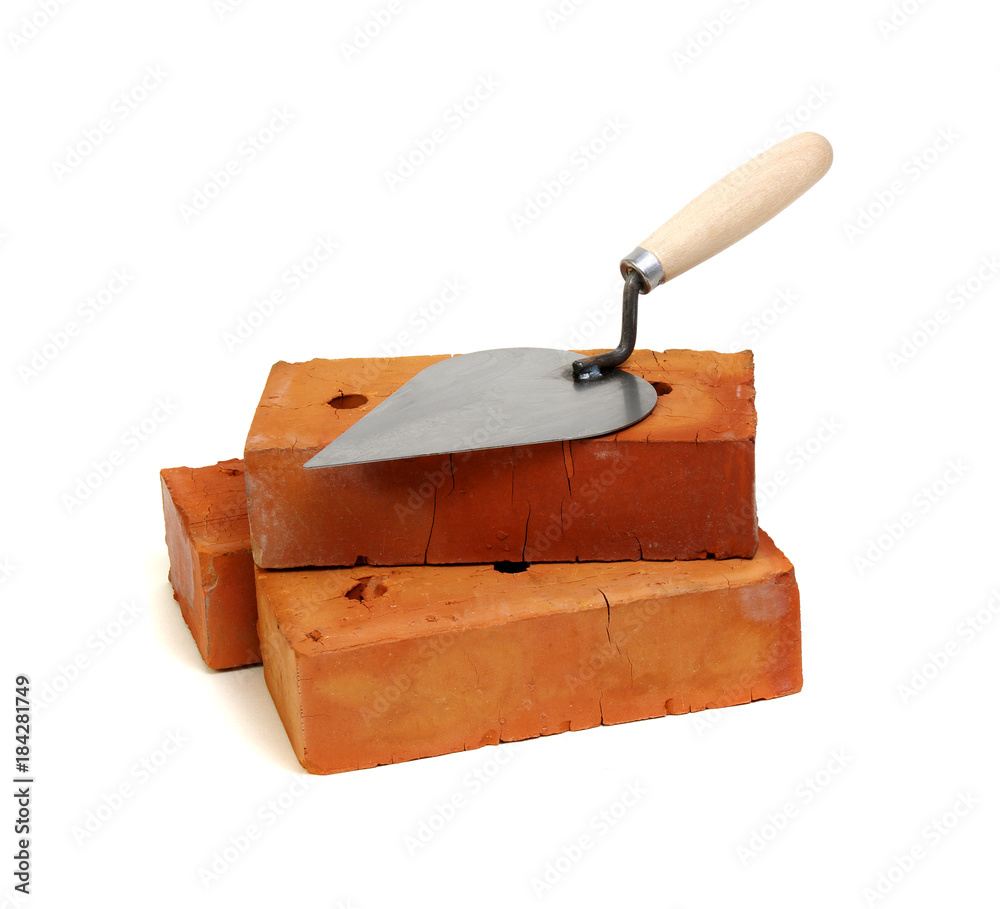 Brick and trowel on a white