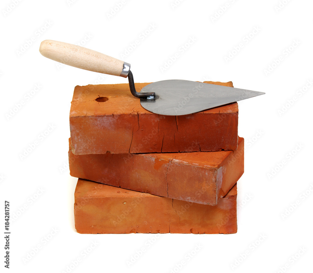 Brick and trowel on a white