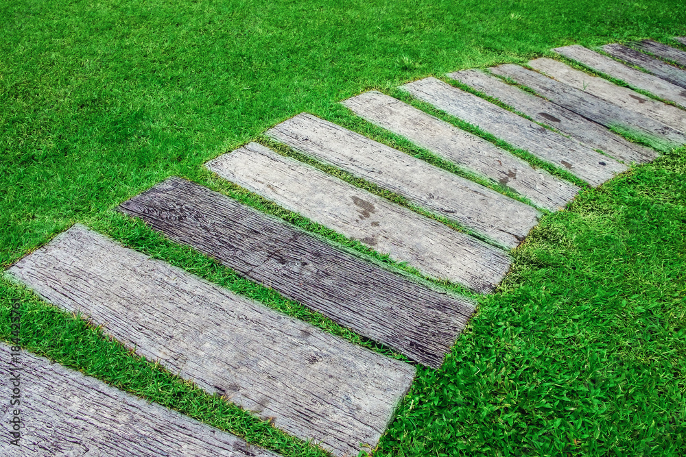 Path from the planks on the grass