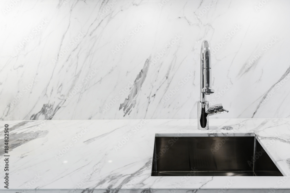 close up sink or lavatory with white marble counter interior background