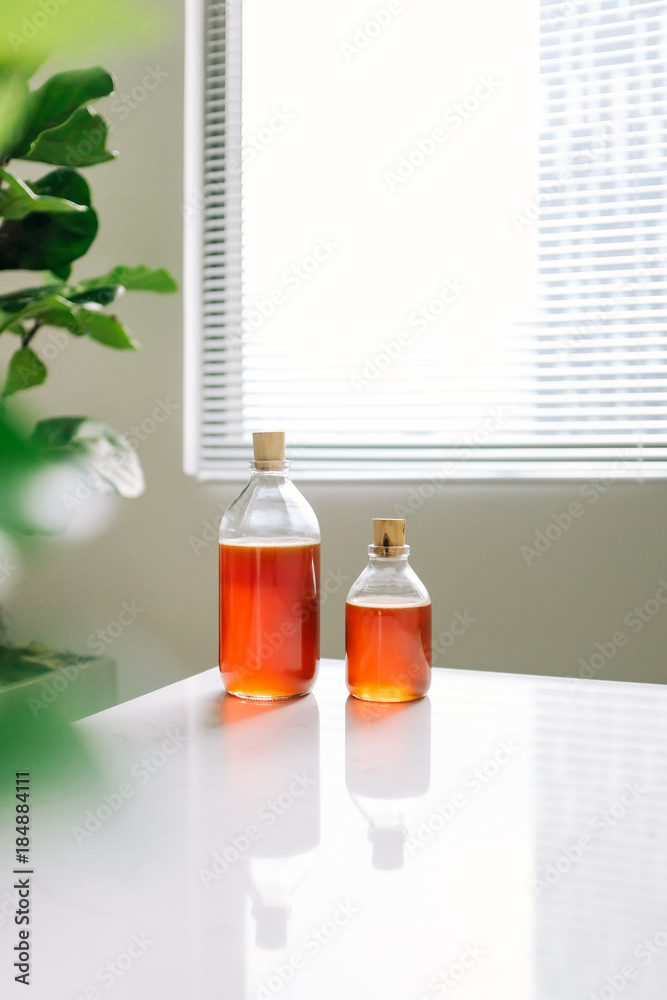 Glass can full of honey on table.