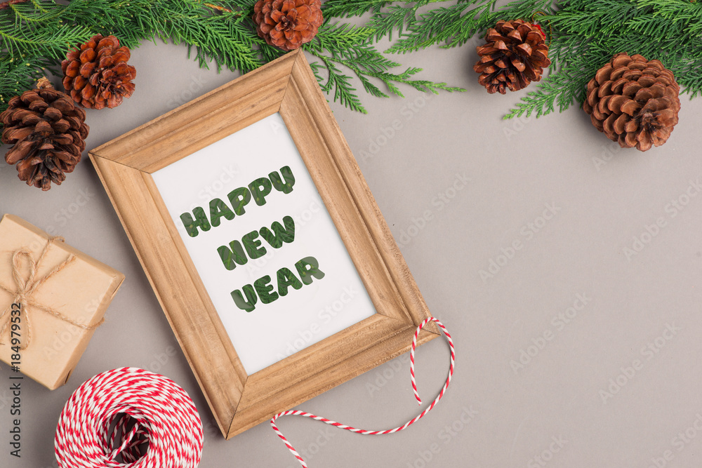 Happy New Year. Gift boxes collection wrapped in kraft paper and blank photo frame for text.