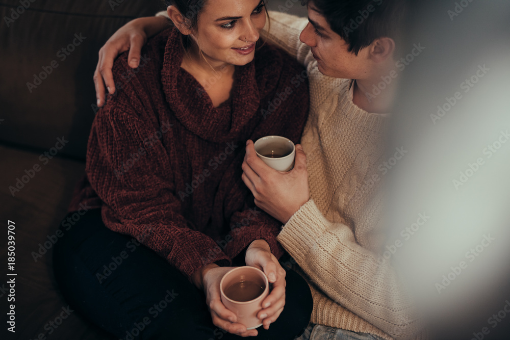 Affectionate couple at home with coffee