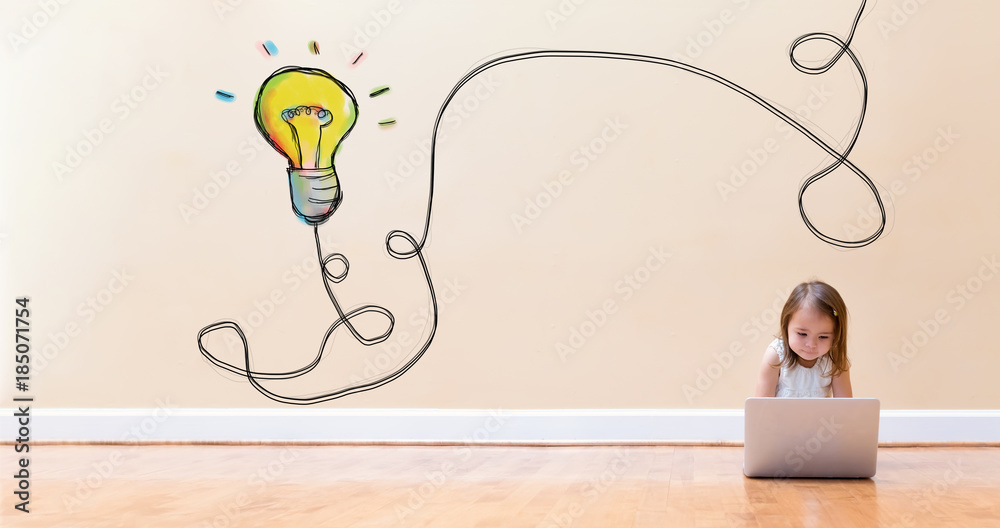 Light Bulb with little girl using a laptop computer on floor