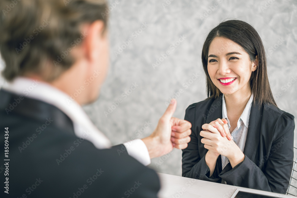 Boss/Business man employer admires young Asian business woman/staff/employee by thumb up and clap wi