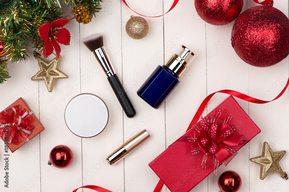 Flat lay of christmas ball, gift and cosmetic. Holiday Background. Beauty concept.