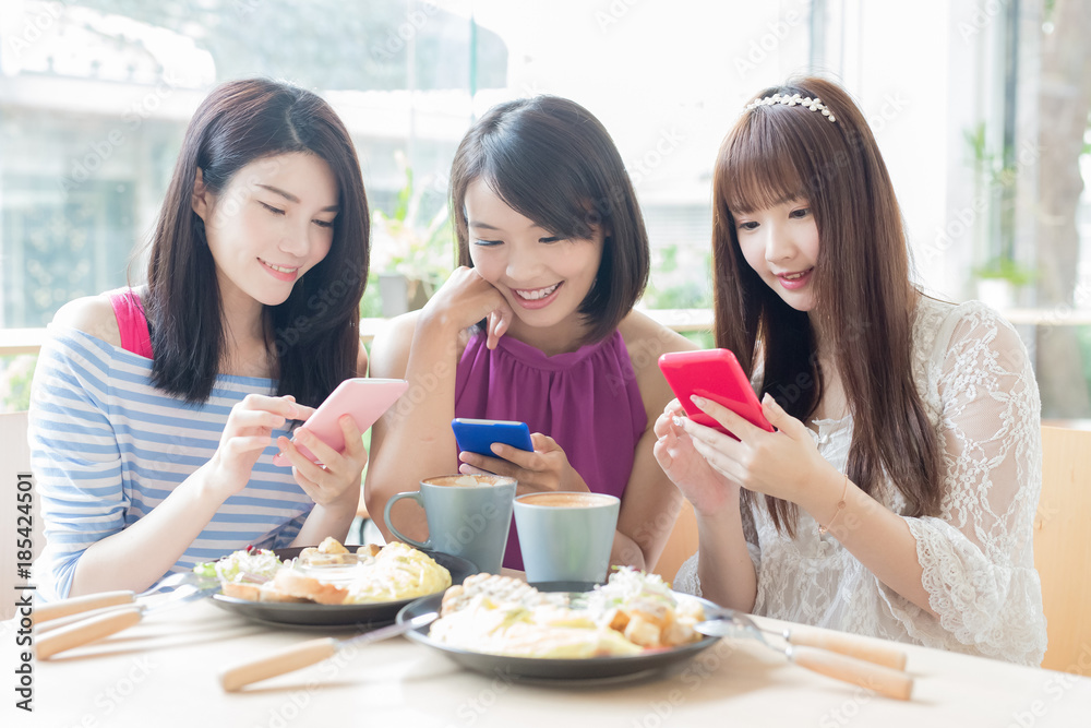 happy woman friends in restaurant