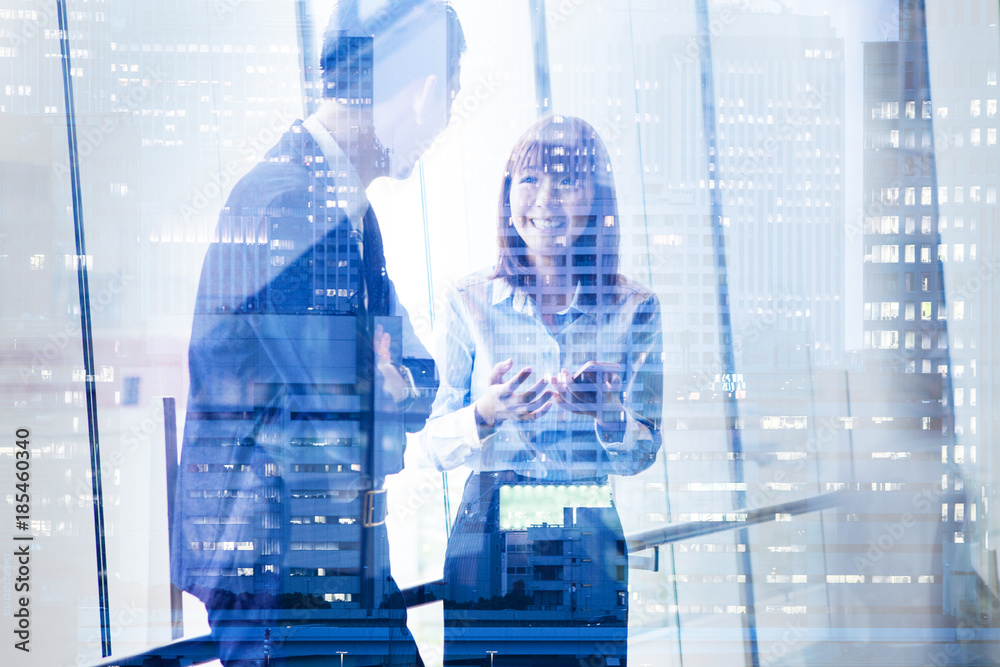 Businesswoman showing mobile phone to colleague in office