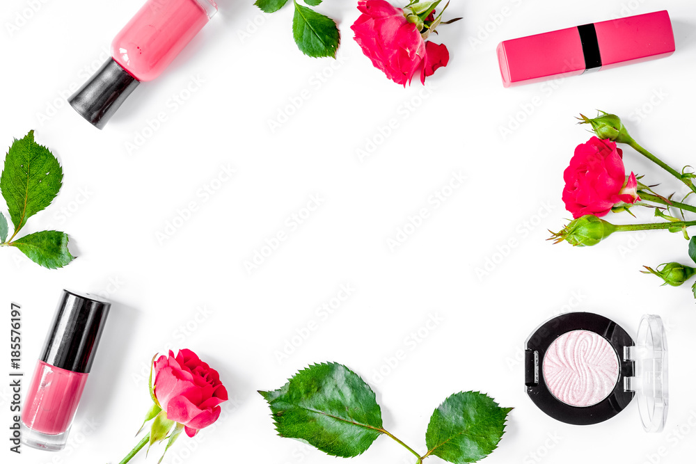 berry color decorative cosmetics with roses white background top