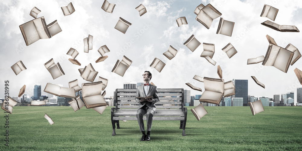 Young businessman or student studying the science in summer park