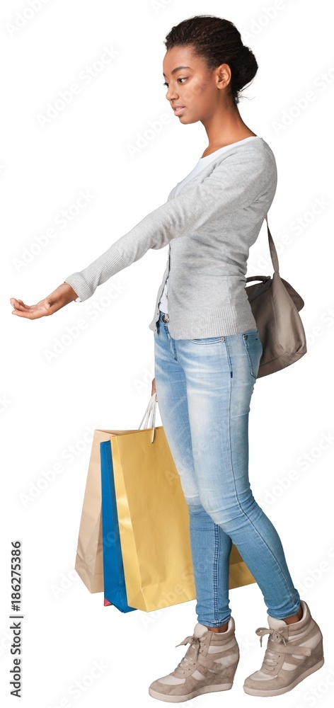 Young woman with shopping bags isolated on white