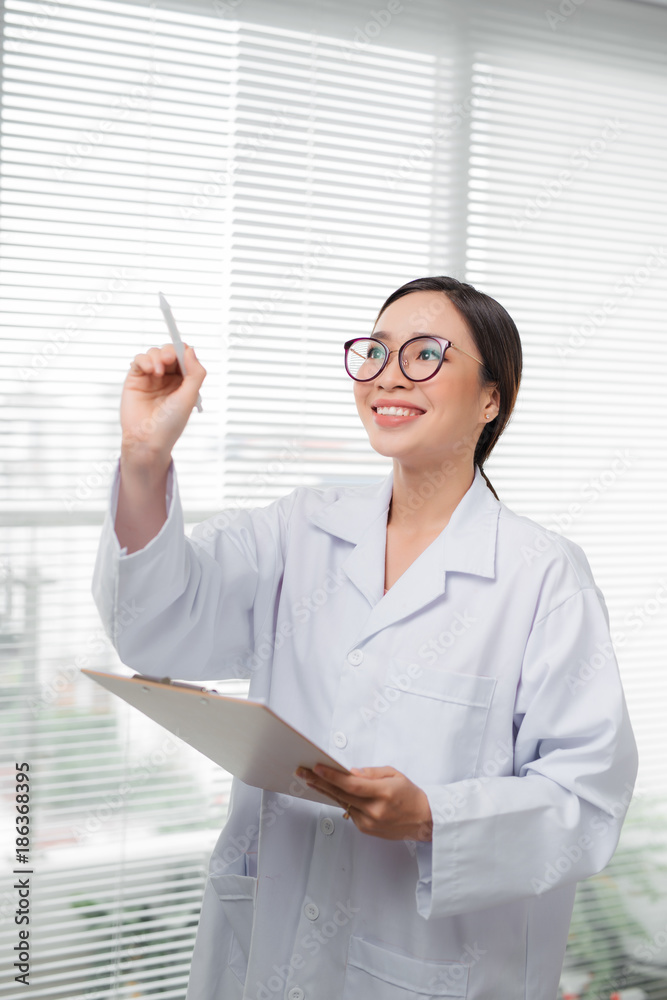 Doctor asian female writing something with marker