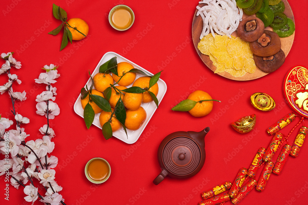 Flat lay Chinese new year new year table top shot. Toddler stealing food from table.