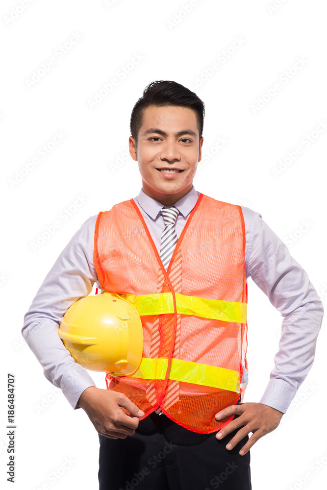 Young engineer with yellow helmet is isolated on white background.