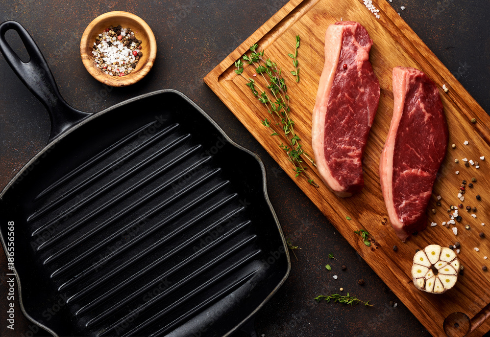 Raw fresh meat Picanha steak, traditional Brazilian cut with thyme, garlic, and black pepper on wood