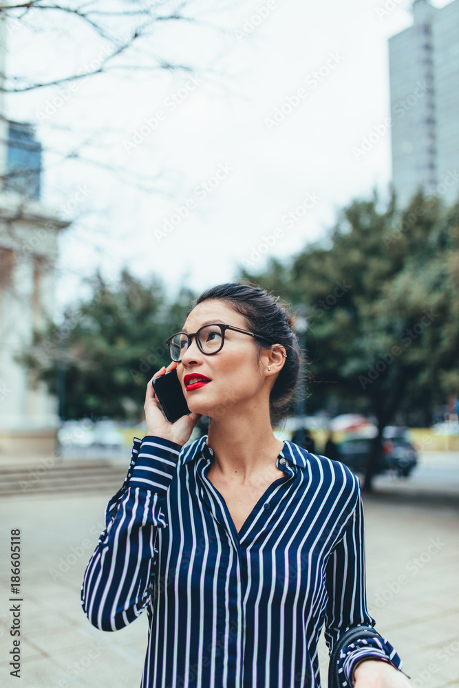 亚洲女商人用手机出门