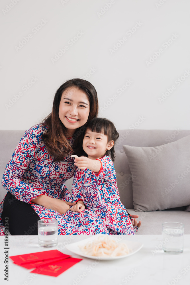 Vietnamese mother and daughter celebrate new year at home. Tet Holiday.