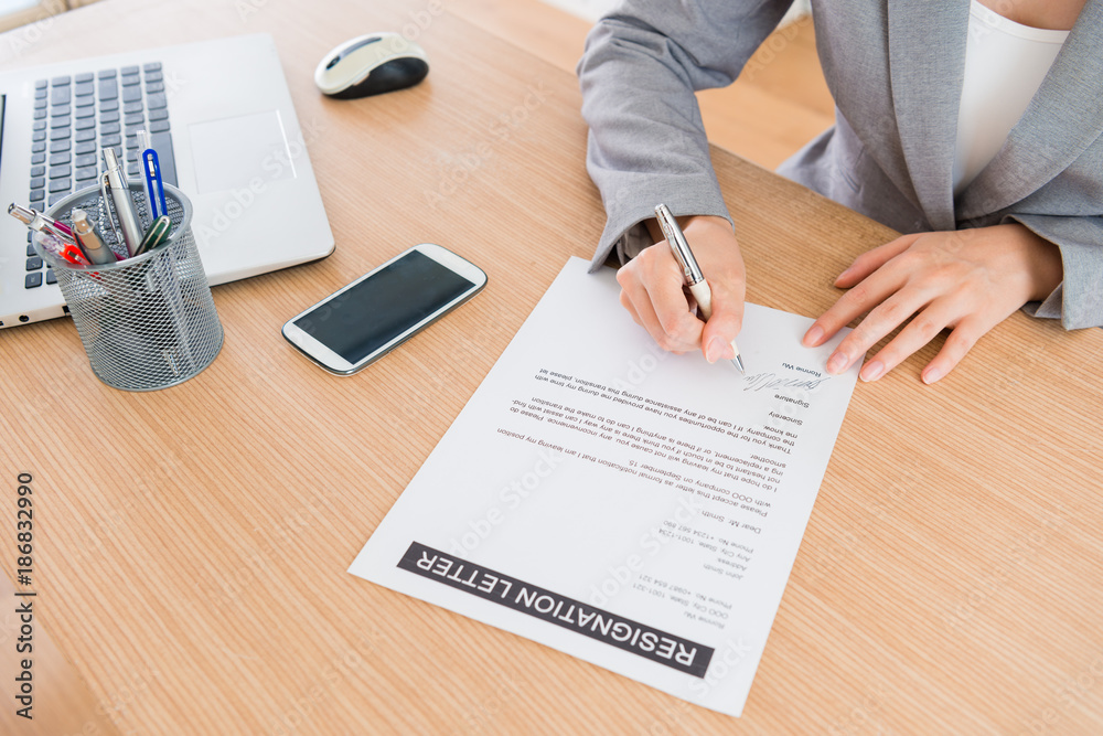 office worker writing resignation letter