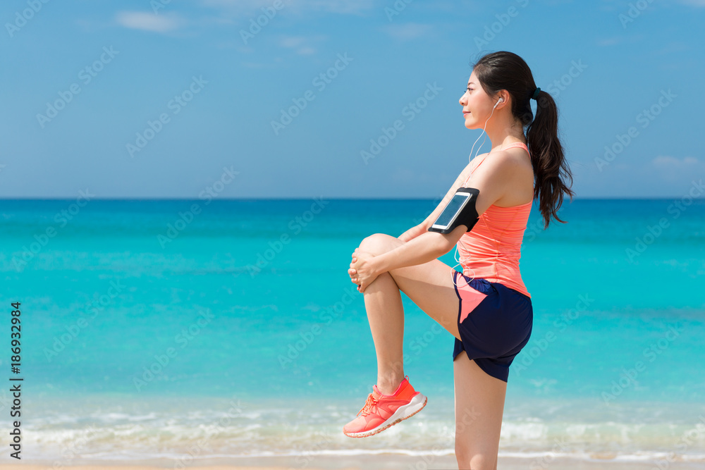 beauty young fitness runner woman doing warm up