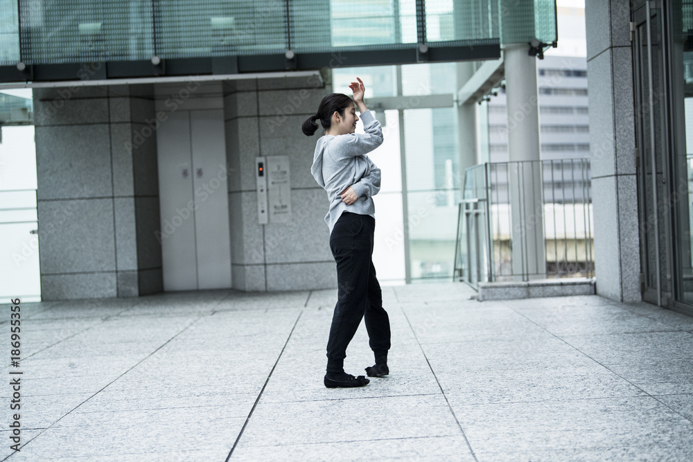 A woman dancing in an office town