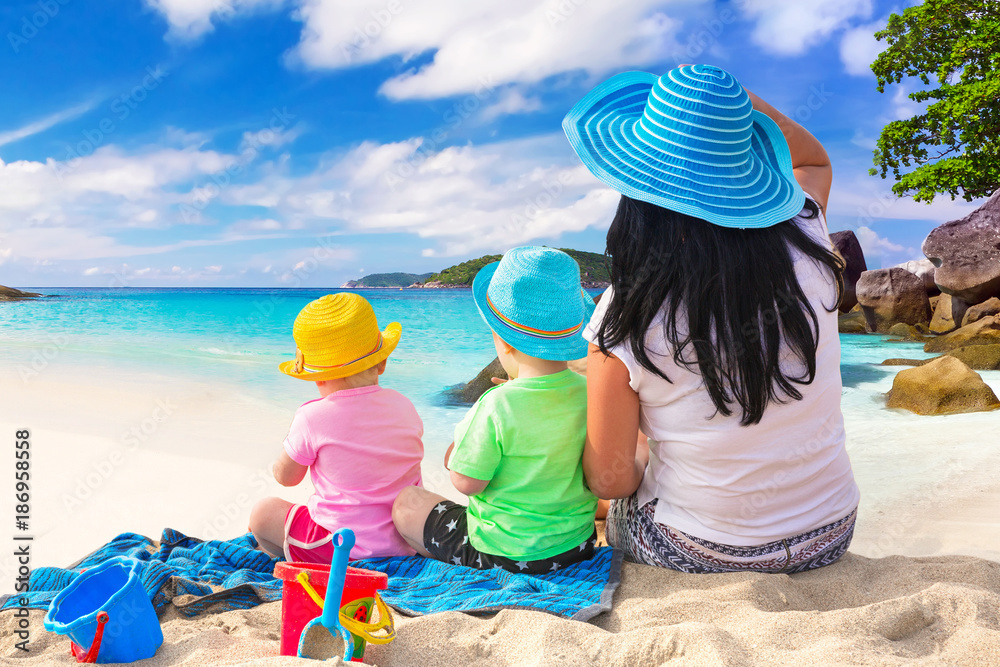 Mother with twins on the tropical beach holidays