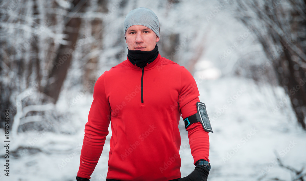 Athlete wearing warm sporty running clothes, winter exercise outdoor