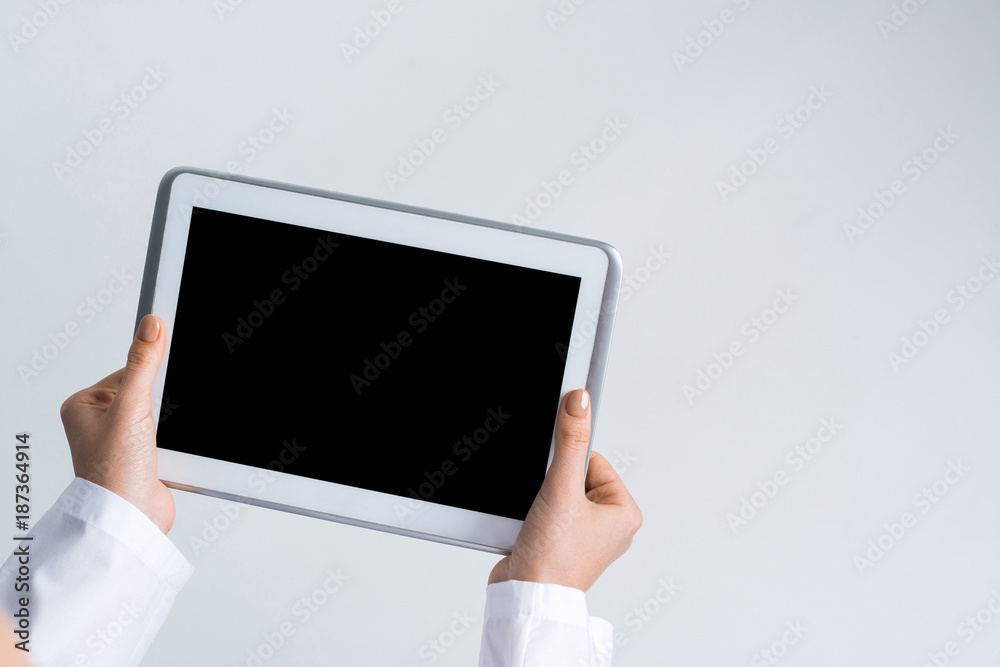 Close of female doctor hands working with tablet pc computer