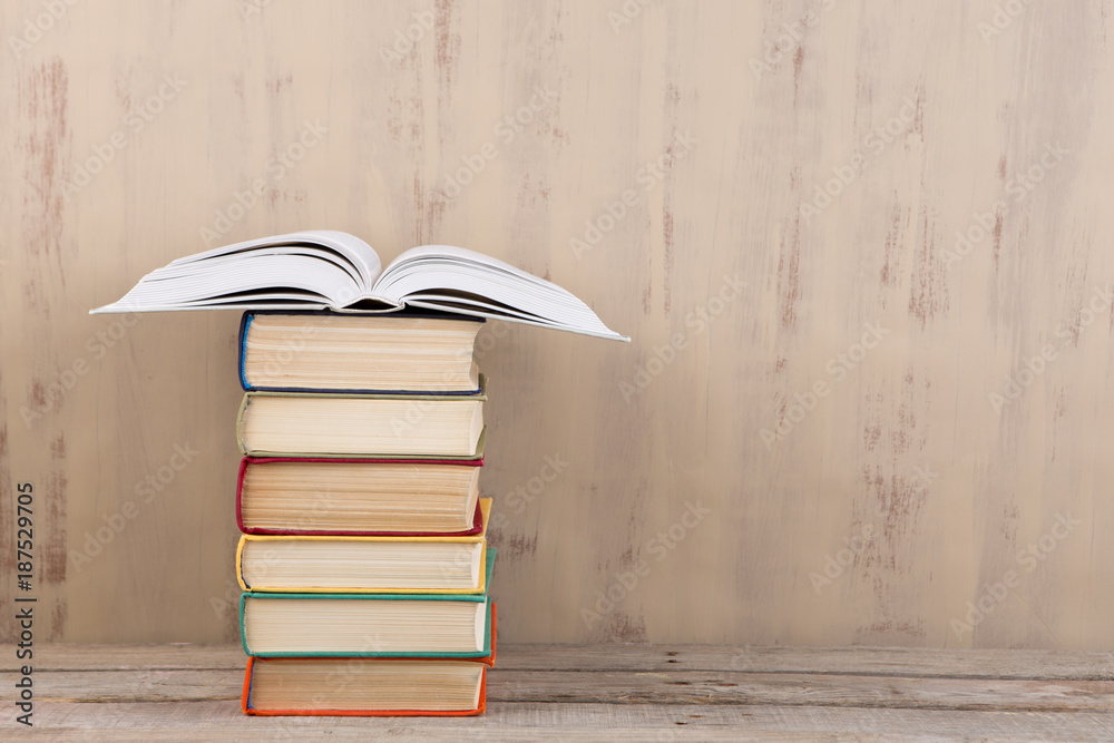 Education and reading concept - group of colorful books on the wooden table