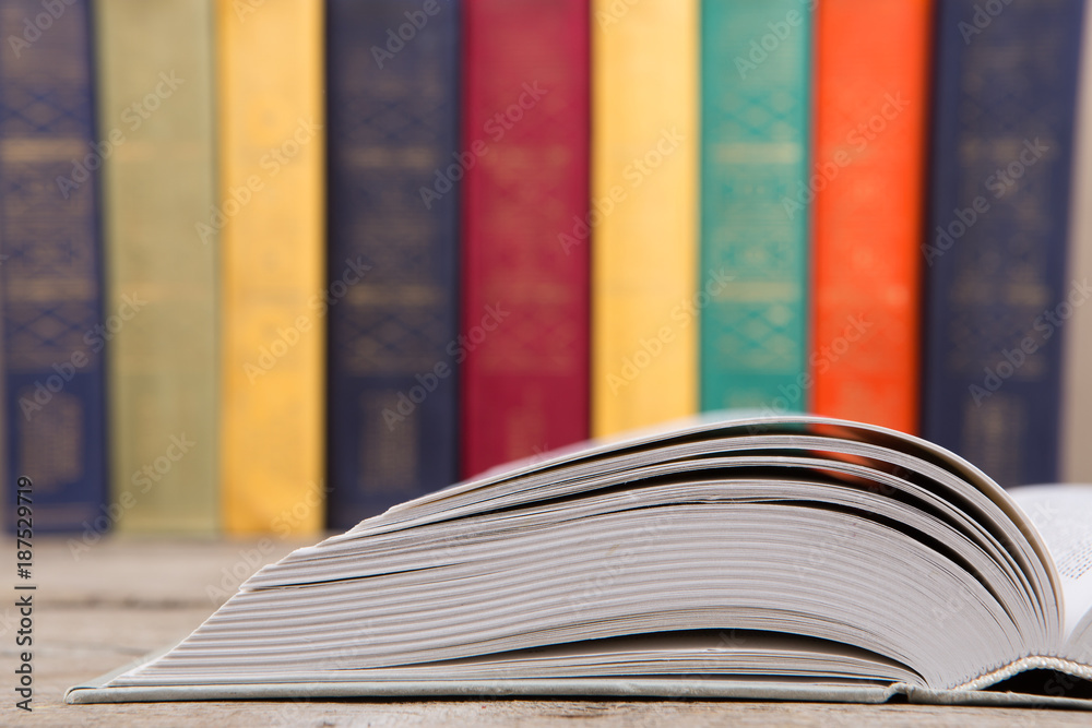 Education and reading concept - group of colorful books on the wooden table