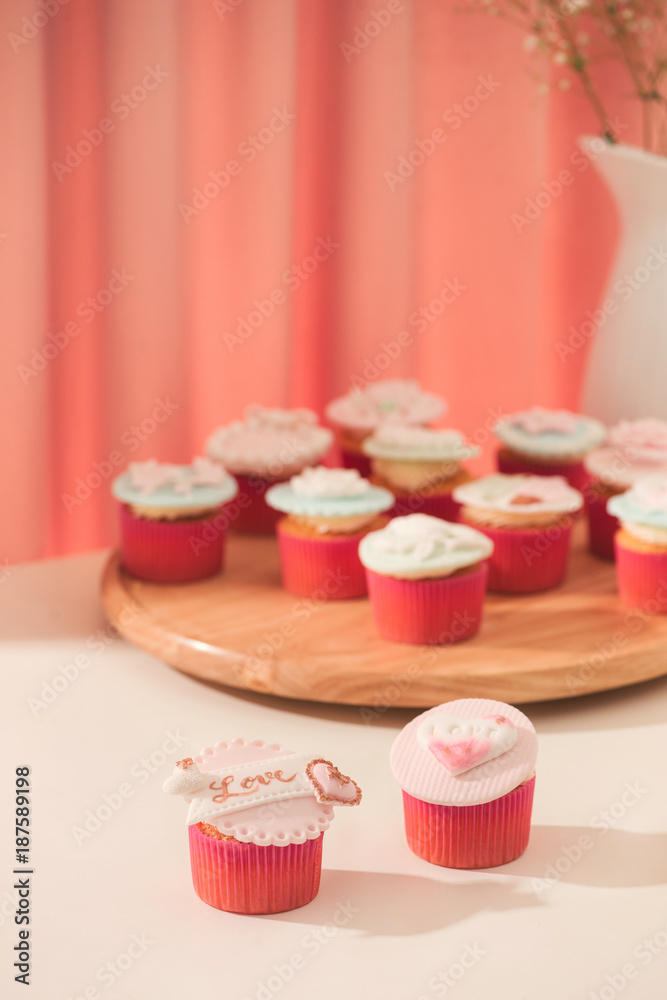 Many yummy cupcakes. Valentine sweet love cupcake on table on light background